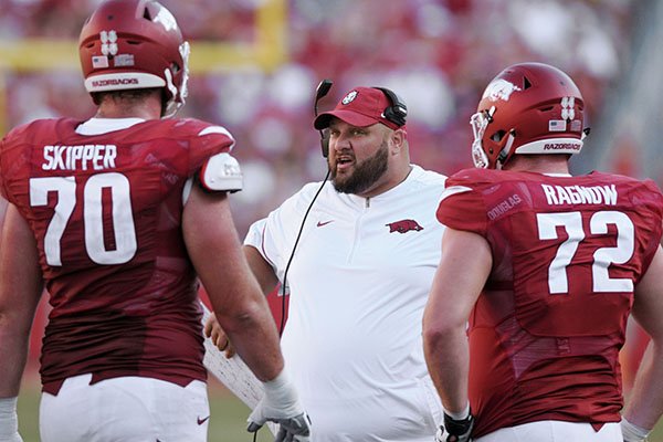 Arkansas offensive line coach Kurt Anderson talks to Dan Skipper and Frank Ragnow during a game against Louisiana Tech on Saturday, Sept. 3, 2016, in Fayetteville.