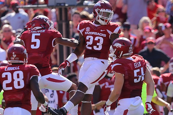 Arkansas linebacker Dre Greenlaw (23) celebrates with cornerback Henre' Toliver (5) after intercepting a pass during a game against Louisiana Tech on Saturday, Sept. 3, 2016, in Fayetteville. 