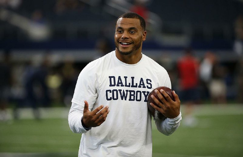 Dallas Cowboys quarterback Dak Prescott smiles during warm ups before the Dallas Cowboys take on the Houston Texans in a preseason NFL football game, Thursday, Sept. 1, 2016, in Arlington, Texas. 