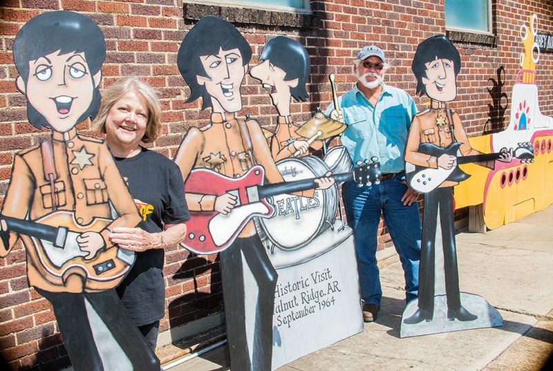 Carrie Mae Snapp, left, stands with some of the cutouts of the Fab Four outside her store on Abbey Road in Walnut Ridge with her brother, Mayor Charles Snapp, as they prepare for the upcoming Beatles at the Ridge festival.