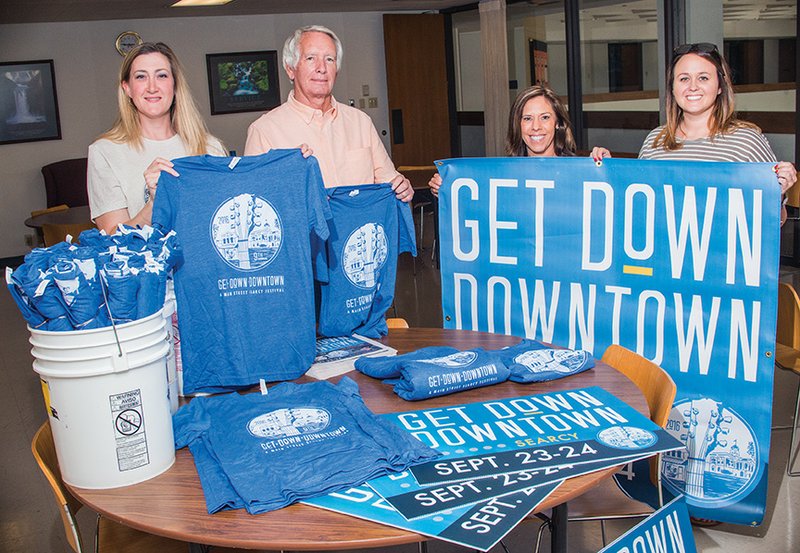 Amy Burton, from left, executive director of Main Street Searcy, and James Carson, vice president of the Main Street Searcy board, prepare for the organization’s ninth annual Get Down Downtown with committee members Lisa Hoffmann and Paige Norman.