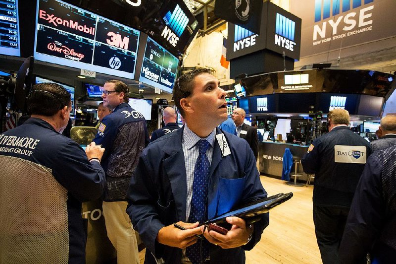 Traders work Friday on the floor of the New York Stock Exchange, where broad losses wiped out recent gradual gains.