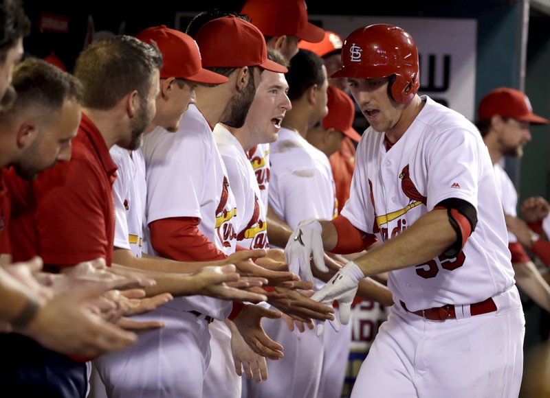 St. Louis Cardinals' Stephen Piscotty, right, is congratulated by teammates after hitting a two-run home run during the third inning of a baseball game against the Milwaukee Brewers on Friday, Sept. 9, 2016, in St. Louis. 