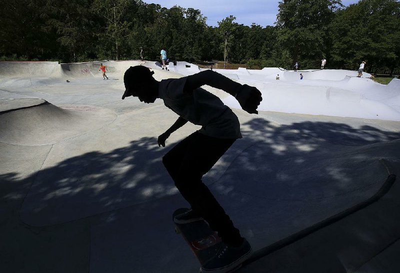 Chemar Belt, 16, of Little Rock rides his skateboard Saturday after a ribbon-cutting ceremony for the newly expanded skate park at Kanis Park in Little Rock. More photos are available at arkansasonline.com/galleries. 