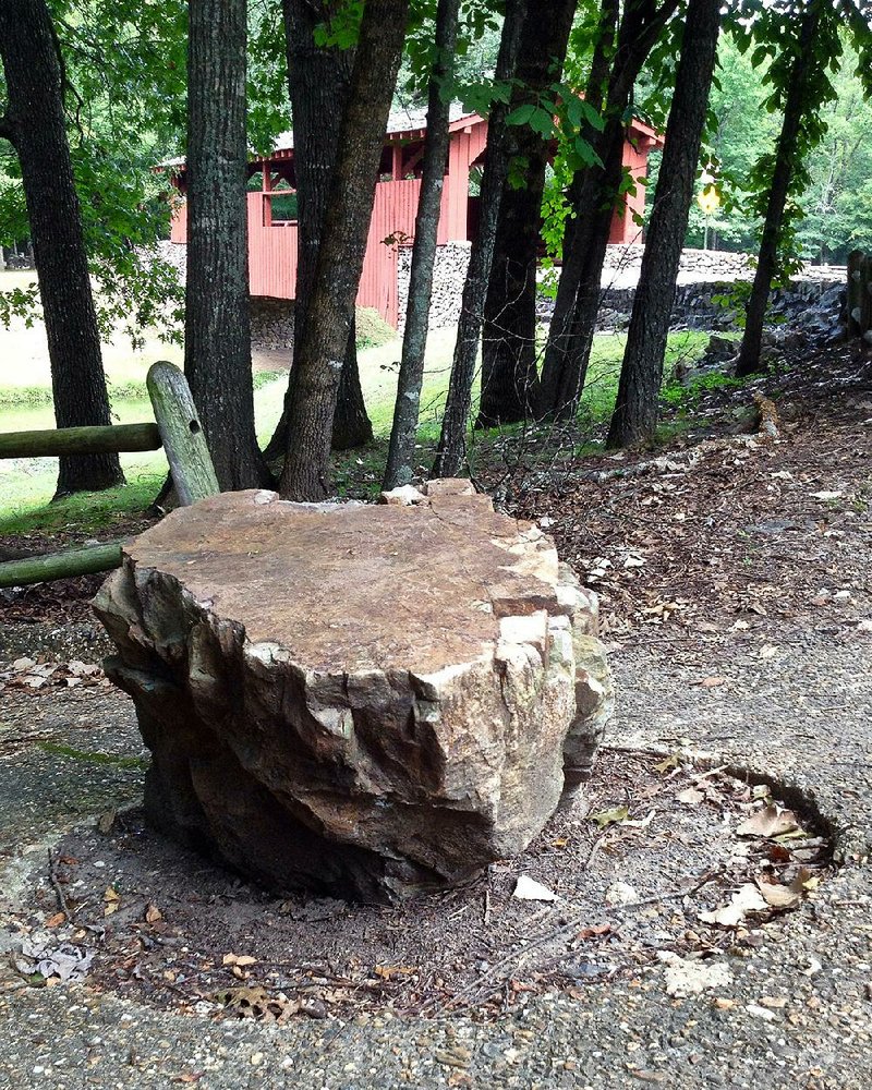 The sidewalk accommodates this trailhead rock off Arlene Laman Drive in Burns Park, North Little Rock, near the covered bridge. 