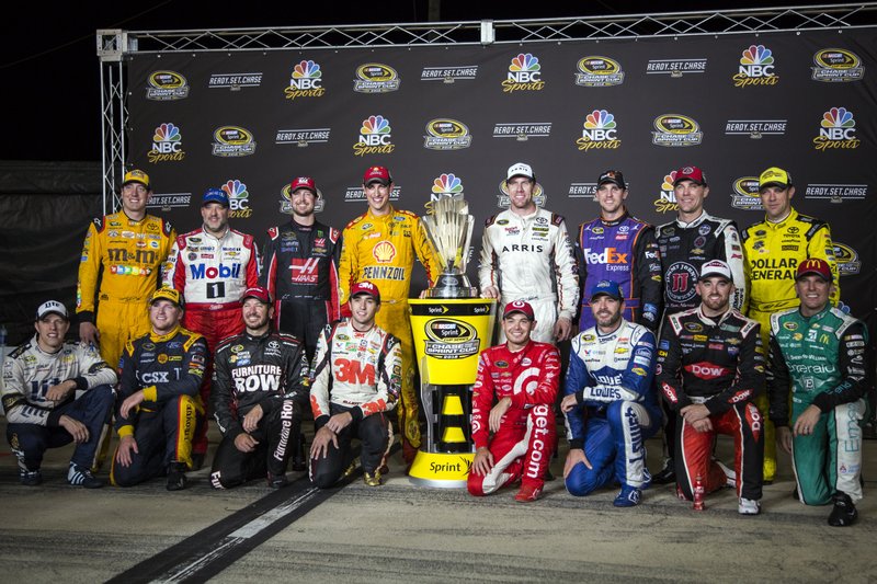 The drivers who have made it into the Chase pose after the NASCAR Sprint Cup auto race at Richmond International Raceway in Richmond, Va., ealry Sunday, Sept. 11, 2016. Standing, from left, are Kyle Busch, Tony Stewart, Kurt Busch, Joey Logano, Carl Edwards, Denny Hamlin, Kevin Harvick and Matt Kenseth. Kneeling are, from left, Brad Keselowski, Chris Buescher, Martin Truex Jr., Chase Elliott, Kyle Larson, Jimmie Johnson, Austin Dillon and Jamie McMurray 