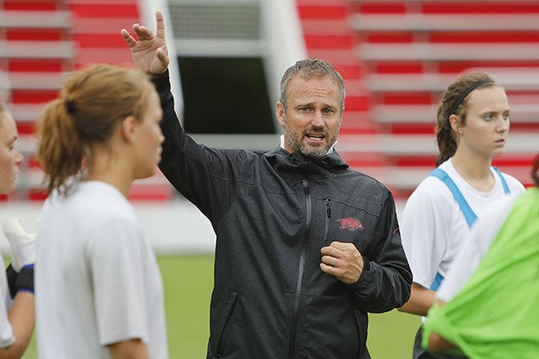 Arkansas soccer coach Colby Hale talks to his players during practice Wednesday, Aug. 19, 2015, in Fayetteville. 