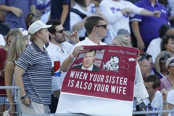 A TCU fan holds up a derogatory sign during a game against Arkansas on Saturday, Sept. 10, 2016, in Fort Worth, Texas. 