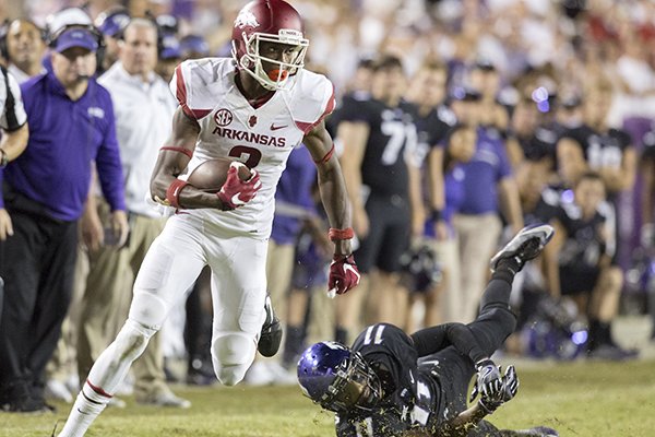 Arkansas senior wide receiver Dominique Reed slips by TCU junior cornerback Ranthony Texada following a reception in the second overtime on Saturday, Sept. 10, 2016, at Amon G. Carter Stadium in Fort Worth, Texas.