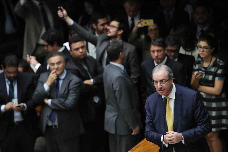 Eduardo Cunha (right) speaks in his defense Monday in the Chamber of Deputies in Brasilia, Brazil. Cunha, who was stripped of his seat over accusations that he lied about having secret Swiss bank accounts, contended he was being punished for leading the ouster of former President Dilma Rousseff. 