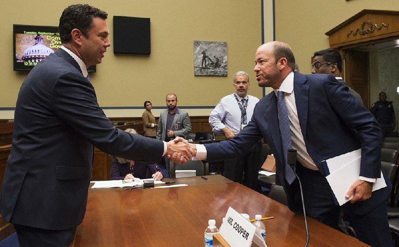 House Oversight and Government Reform Committee Chairman Rep. Jason Chaffetz, R-Utah, (left) shakes hands with Justin Cooper, a former Bill Clinton aide and the administrator of a private email server used by Hillary Clinton, after Cooper testified Tuesday on Capitol Hill in Washington.