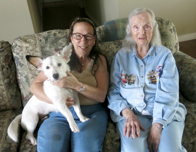 Vicky Barham (left) and her Corgi mix, Baylor, visited her neighbor, Lavern Glenn, a few days after Baylor helped rescue Glenn.