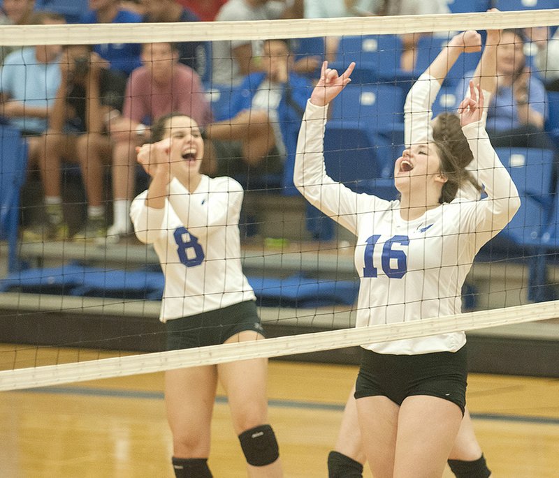 Rogers’ Madelyn Tauai (8) and Alex Parish celebrate a point against Van Buren on Tuesday in Rogers.