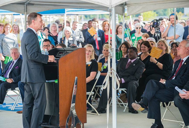 Conway Mayor Tab Townsell addresses the crowd at the dedication of the $150 million Baptist Health Medical Center-Conway, which opens at 7 a.m. Friday. Also pictured are Gov. Asa Hutchinson, right, and Joanie White-Wagoner, front row left, partially hidden by podium, vice president and administrator of the Conway facility.