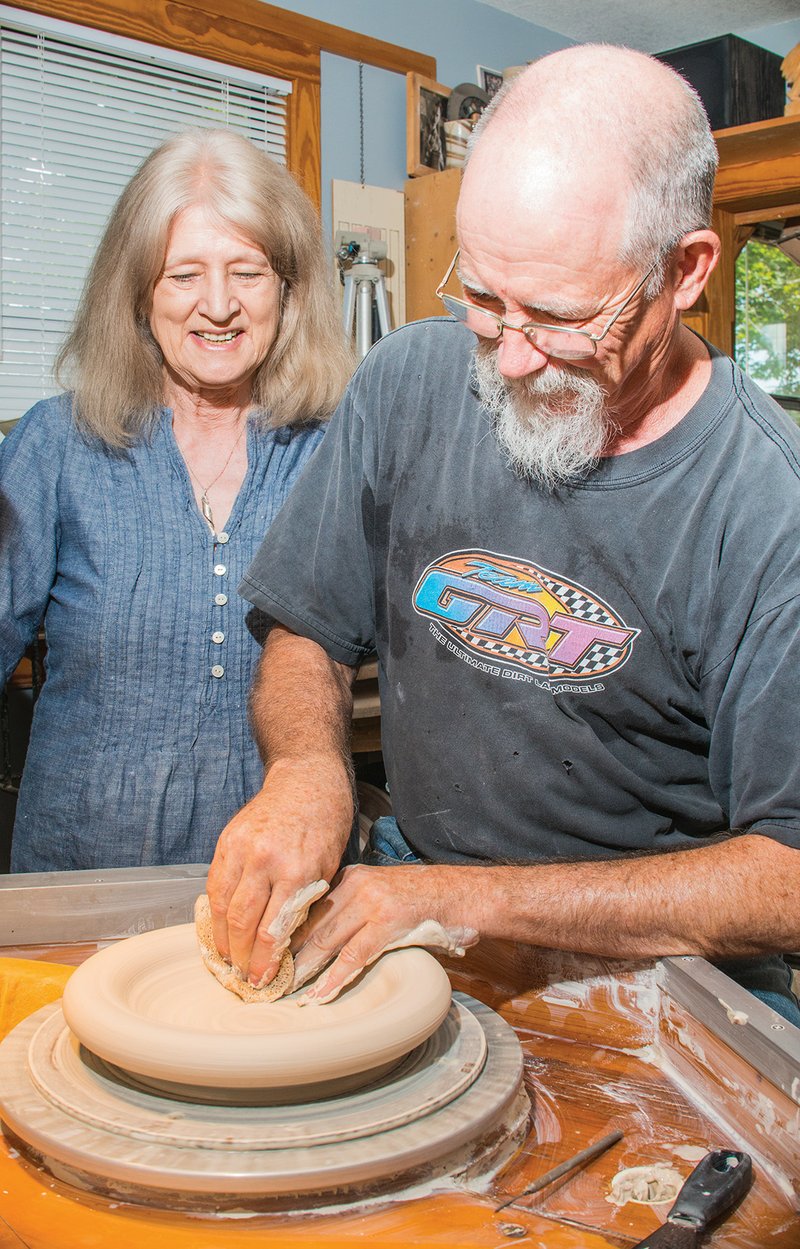 Becki Dahlstedt stands next to her husband, David Dahlstedt, as he works on a bowl in their Mountain View pottery studio, Dahlstedt Pottery. Becki Dahlstedt is the tour coordinator for the Off the Beaten Path Studio Tour, which takes place Friday and Saturday in Mountain View and includes the couple’s studio.