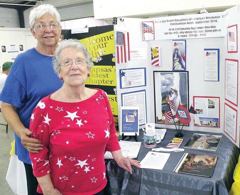 Alice George, left, and Virginia Kelley, members of the Maria Van Buren chapter of the  Arkansas State Society Daughters of the American Revolution, stand in front of the chapter’s Constitution Week display at the 
Van Buren County Fair in Clinton. The display will remain on exhibit through the close of the fair on Saturday.