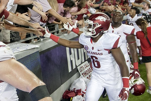 Arkansas freshman running back TJ Hammonds celebrates with fans on Saturday, Sept. 10, 2016, following the Razorbacks' 2OT win over TCU at Amon G. Carter Stadium in Fort Worth, Texas. "ARKANSAS" is misspelled as "AKRANSAS" on Hammonds' jersey front.