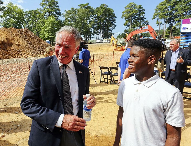 University of Arkansas at Little Rock Chancellor Andrew Rogerson visits Wednesday with Jarron Gray, an eStem high school student, on the UALR campus.