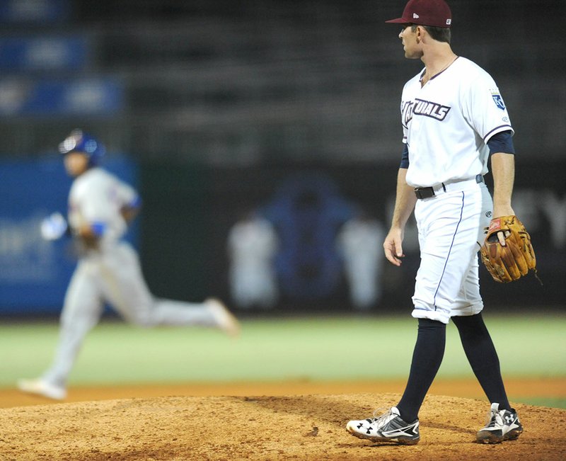 Northwest Arkansas Naturals reliever Reid Redman watches as Midland shortstop Richie Martin rounds the bases Wednesday after hitting a solo home run during the sixth inning at Arvest Ballpark in Springdale.