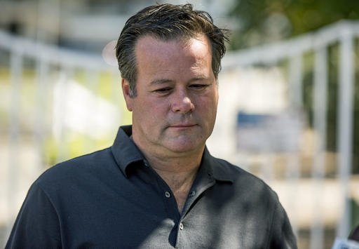 Former NASCAR racer Robby Gordon pauses while making a statement to members of the media gathered outside his home in Orange, Calif., on Thursday, Sept. 15, 2016. 