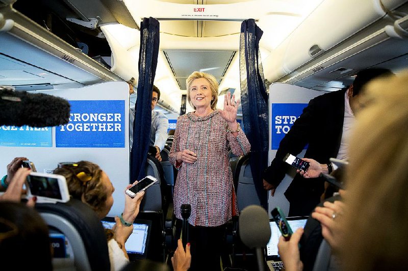 Democratic presidential candidate Hillary Clinton speaks to reporters Thursday on her campaign plane in White Plains, N.Y., while traveling to Greensboro, N.C., for a rally. 
