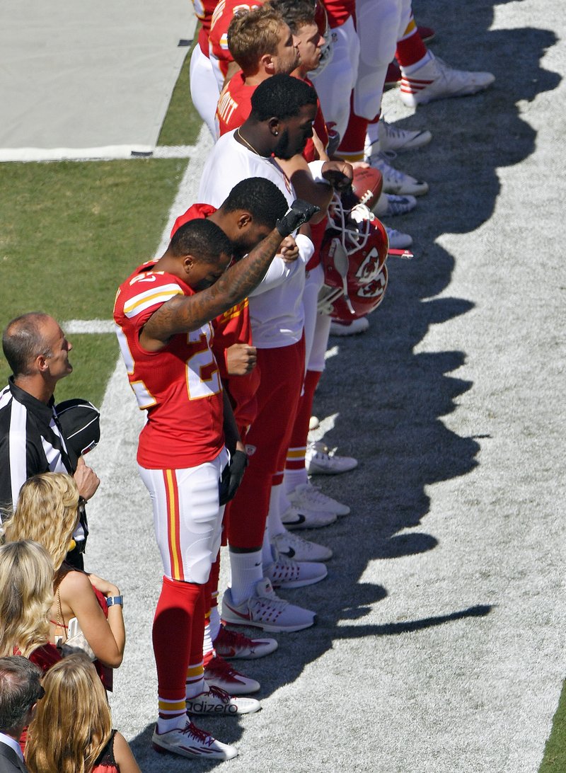 In this Sunday, Sept. 11, 2016, file photo, Kansas City Chiefs' Marcus Peters raises his fist in the air during the national anthem before an NFL football game against the San Diego Chargers in Kansas City, Mo.