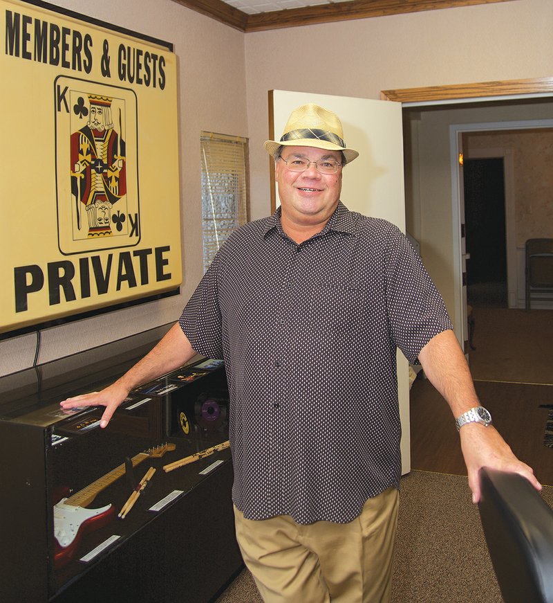 Henry Boyce, festival chairman for the Depot Days Festival in Newport, stands next to an original sign that used to hang in Bob King’s King of Clubs Nightclub in Jackson County.