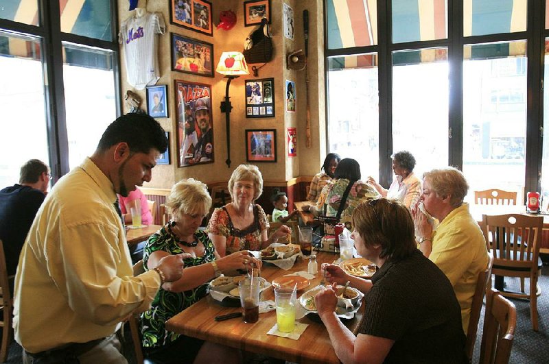 Customers lunch at an Applebee’s in New York in this file photo. Sales at the Applebee’s chain slipped in the first two quarters of this year. 