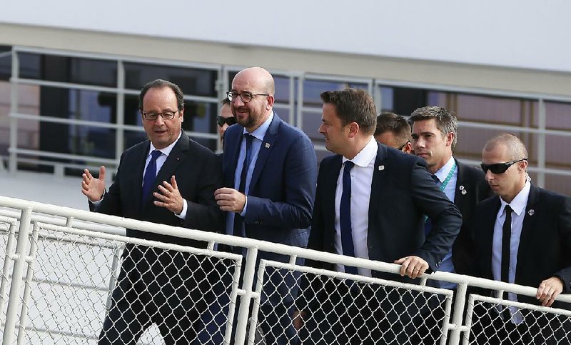 French President Francois Hollande (left) speaks Friday with Belgian Prime Minister Charles Michel (center) and Luxembourg’s Prime Minister Xavier Bettel after a cruise on the Danube River, a sidelines event of an European Union summit in Bratislava, Slovakia.