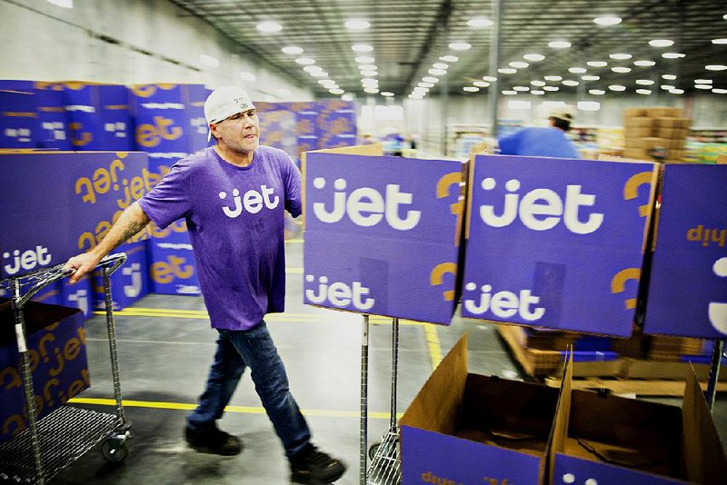 An employee pushes a cart of empty boxes at the Jet.com fulfillment center in Kansas City, Kan., last year. Wal-Mart Stores Inc. is awaiting regulatory approval to purchase the e-commerce company.