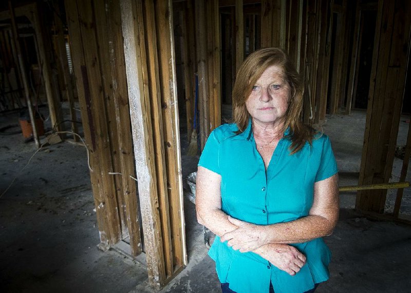Debbie Millet stands in her gutted home Wednesday in Denham Springs, La., which took on 6 feet of water in flooding last month that submerged much of south Louisiana. Like thousands of other homes, everything inside had to be removed, including the ceilings.