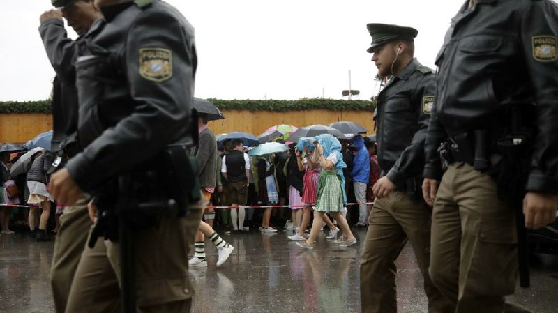 Police officers patrol Saturday as people line up for the opening of the 183rd Oktoberfest beer festival in Munich. 