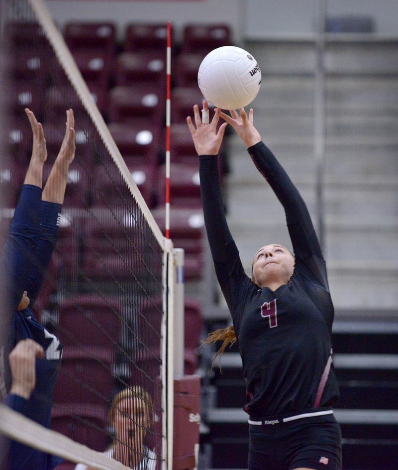 Ben Goff/NWA Democrat-Gazette Chloe Price of Siloam Springs hits the ball over in game one against Greenwood during the match in Siloam Springs&#8217; Panther Activity Center.