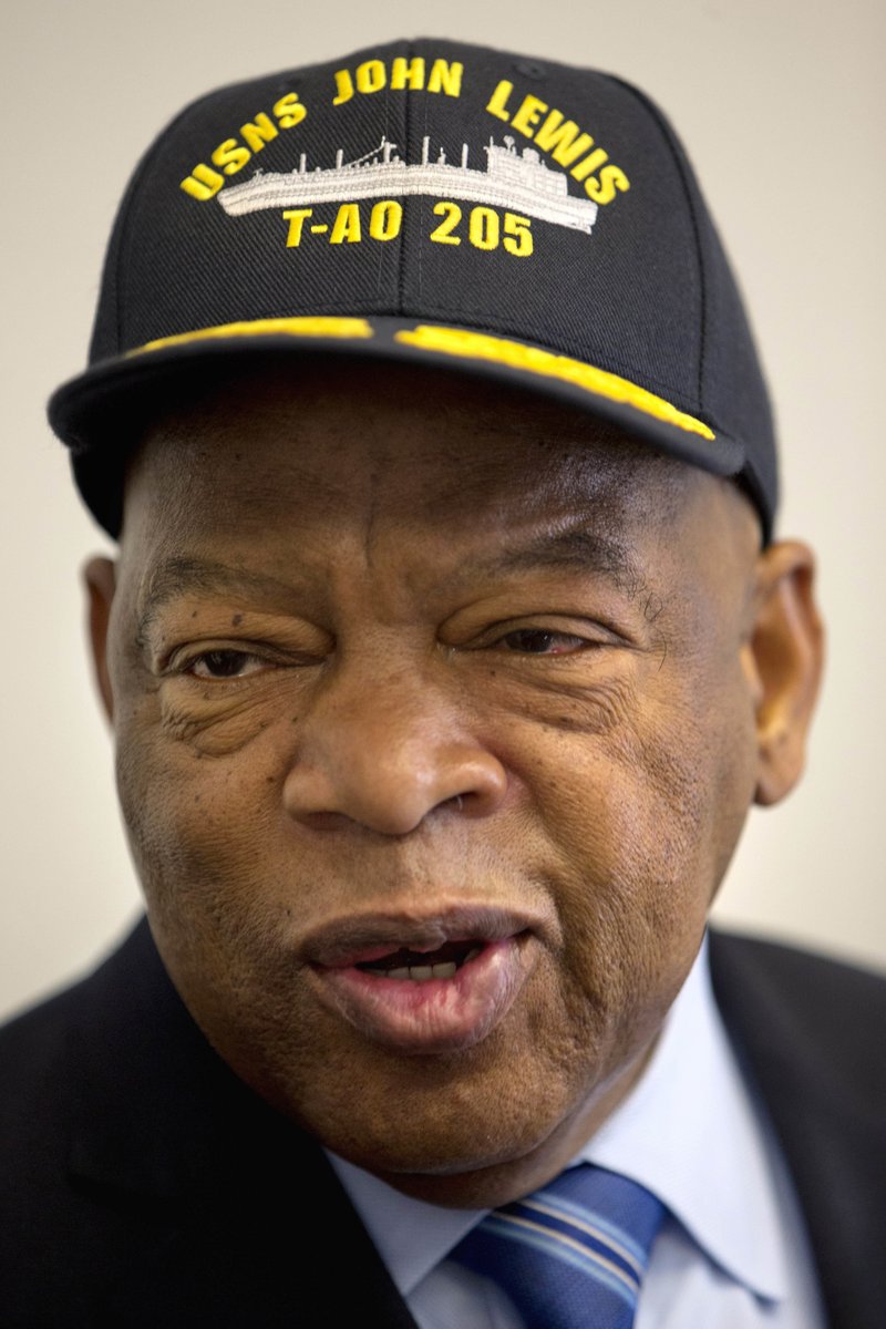 In this Jan. 6, 2016 file photo, Rep. John Lewis, D-Ga., wears a hat bearing the name of a fleet replenishment oiler named after him during a ceremony with Navy Secretary Ray Mabus on Capitol Hill in Washington. 