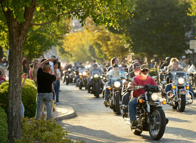 Bikers cruise Dickson Street on Sept. 26, 2015, during the annual Bikes, Blues & BBQ motorcycle rally in downtown Fayetteville.