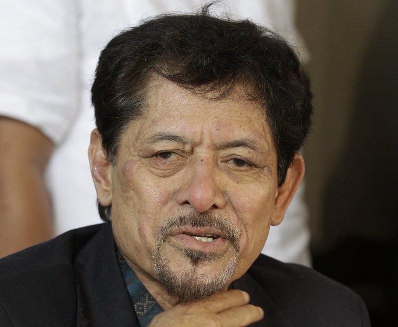 In this March 5, 2013 file photo, Moro National Liberation Front chairman Nur Misuari gestures during a press conference in suburban Taguig, south of Manila, Philippines. 