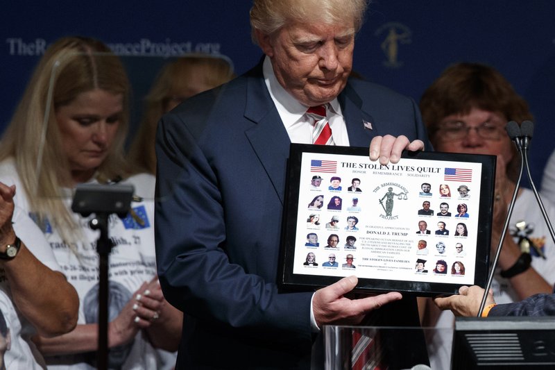 Republican presidential candidate Donald Trump is presented with a gift during an event with The Remembrance Project, Saturday, Sept. 17, 2016, in Houston.