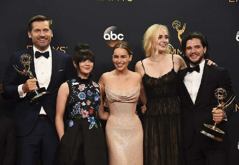 Nikolaj Coster-Waldau (from left), Maisie Williams, Emilia Clarke, Sophie Turner, and Kit Harington celebrate Sunday after Game of Thrones won the award for outstanding drama series at the 68th Primetime Emmy Awards at the Microsoft Theater in Los Angeles.