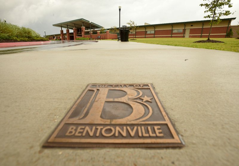 A City of Bentonville logo decorates the sidewalk Friday leading to the entrance of the Bentonville Community Center.