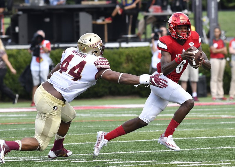 Louisville quarterback Lamar Jackson (8) avoids the tackle form Florida State defensive end DeMarcus Walker (44) during the third quarter of an NCAA college football game, Saturday, Sep. 17, 2016 in Louisville Ky.Louisville won 63-20. (AP Photo/Timothy D. Easley)