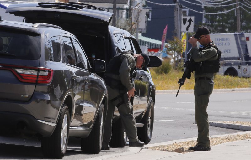 Law enforcement officers stand on D Street in Seaside Park, N.J. on Sept. 17, 2016, during the investigation of an explosive device that detonated in a garbage pail before a charity race to benefit military soldiers. 