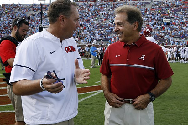 Mississippi head coach Hugh Freeze, left, and Alabama head coach Nick Saban confer prior to their NCAA college football game, Saturday, Sept. 17, 2016 in Oxford, Miss. (AP Photo/Rogelio V. Solis)

