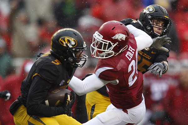 Arkansas safety De'Andre Coley tackles Missouri running back Marquise Doherty during a game Friday, Nov. 27, 2015, in Fayetteville. 