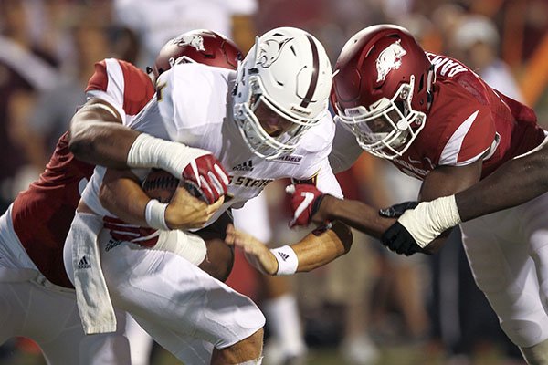 Arkansas defensive linemen Jeremiah Ledbetter, left, and Randy Ramsey sack Texas State quarterback Tyler Jones during a game Saturday, Sept. 17, 2016, in Fayetteville. 