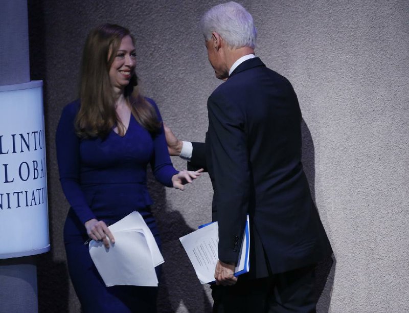 Chelsea Clinton, vice chairman of the Clinton Foundation, enters the stage at the Clinton Global Initiative as her father, former U.S. President Bill Clinton, leaves the stage after speaking Monday in New York.