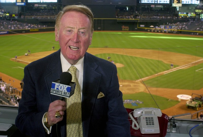 In this July 3, 2002, file photo, Los Angeles Dodgers television play-by-play announcer Vin Scully rehearses before a game between the Dodgers and the Arizona Diamondbacks, in Phoenix. 