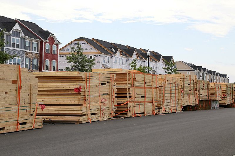Pallets of prefabricated sections for a town-house development sit on a street in the South Riding section of Aldie in Loudoun County, Va., on Sunday. Groundbreakings on new homes fell 5.8 percent to a seasonally adjusted annual rate of 1.14 million, the Commerce Department said Tuesday. 