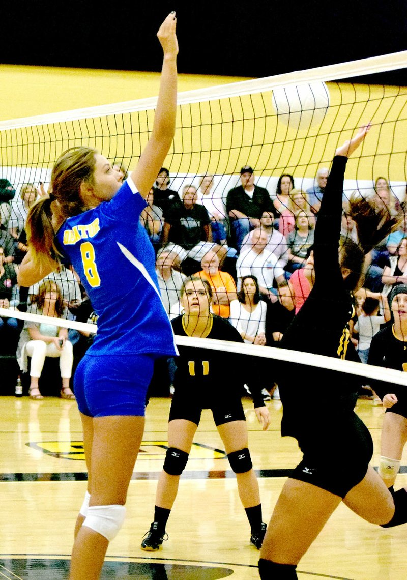 Photo by Mike Eckels Decatur&#8217;s Talor Thompson (8) flicks the ball past a Tiger player during the Sept. 15 senior girls&#8217; volleyball match between the Decatur Bulldogs and the Prairie Grove Tigers in Prairie Grove. The Tigers took the conference victory in three sets.