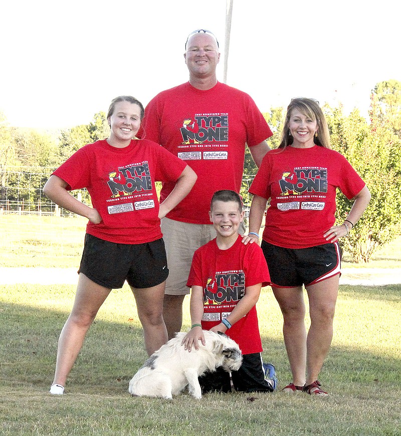 COURTESY PHOTO The Lovell family &#x2014; parents Roy and Stephanie, Madison and Beau &#x2014; display the T-shirts for the 2016 Farmington Hometown Walk to Cure Diabetes. Beau, 10, was diagnosed with Type 1 diabetes two years ago and his family coordinates the walk. Some T-shirts will still be available to purchase at the walk Saturday morning.