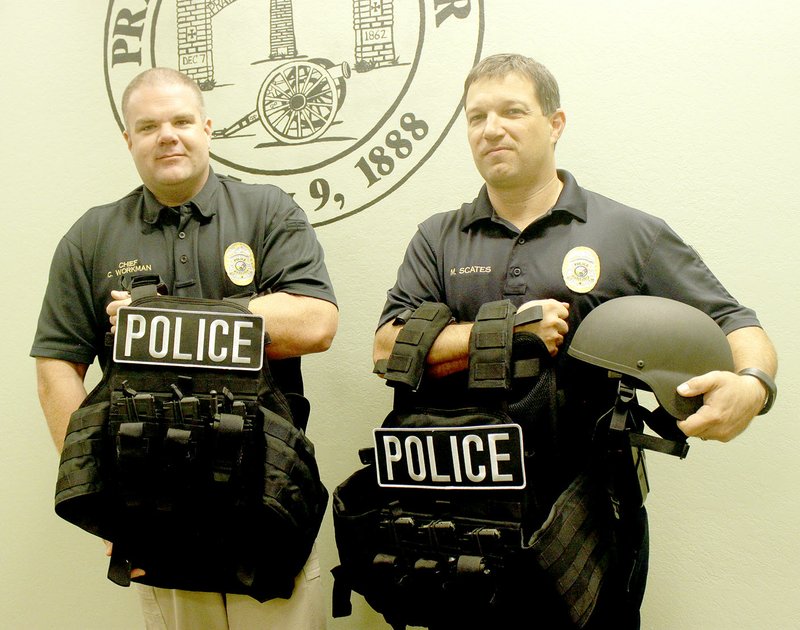 LYNN KUTTER ENTERPRISE-LEADER Prairie Grove Police Chief Chris Workman, left, and Sgt. Mark Scates display new body armor for police officers. The vests weigh 40-45 pounds each when filled with extra ammunition.